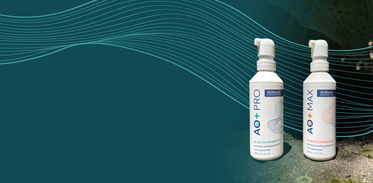 Two bottles of AO+ PRO and AO+ MAX standing on a mossy rock surface with a green leafy background that fades into a dark teal background
