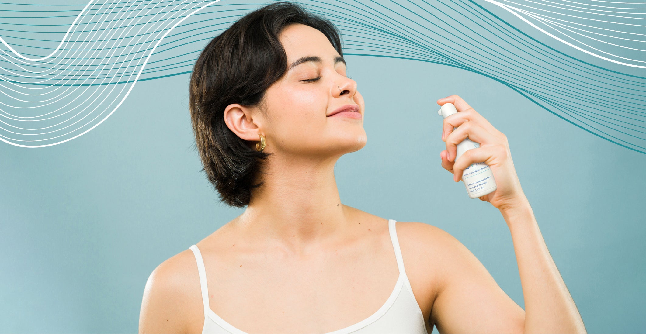 Woman applying AO+ spray product to her face against a light blue background with abstract wavy lines.