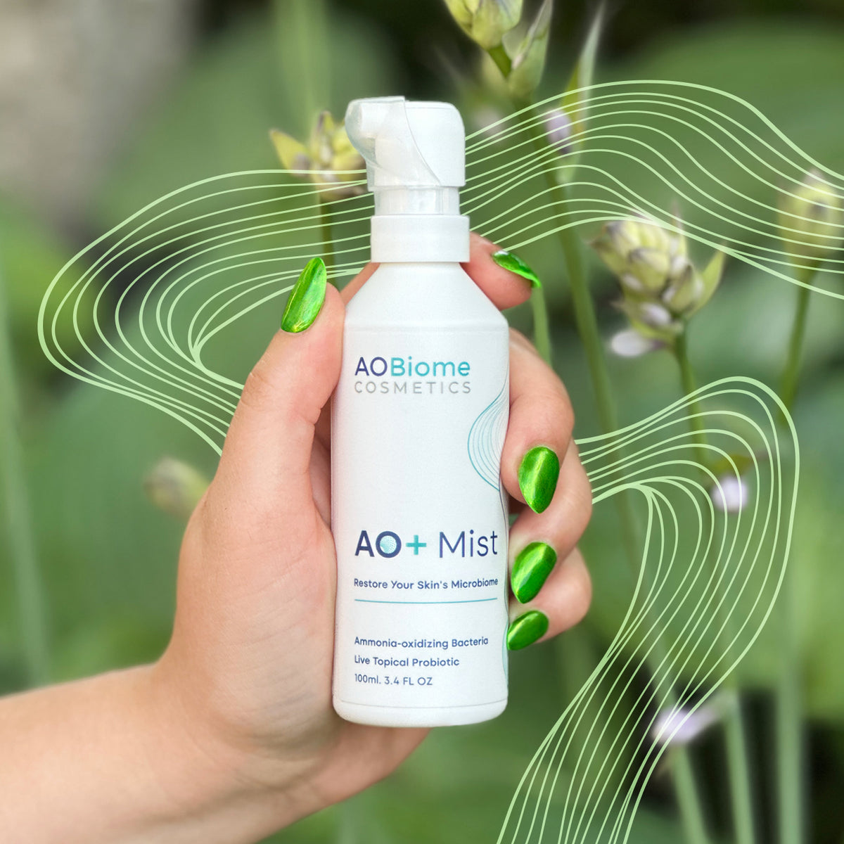 Hand holding a bottle of AO+ Mist against a background of leaves and flower buds