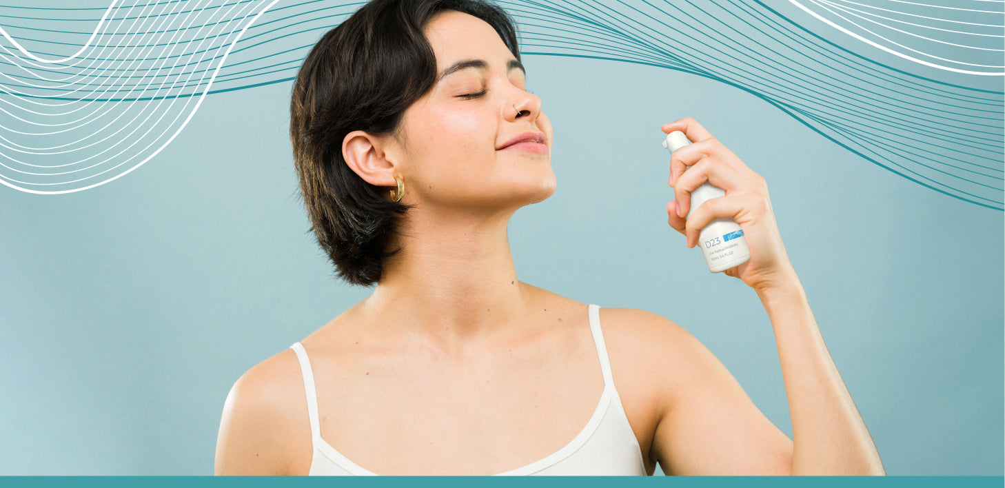 Woman applying AO+ spray product to her face against a light blue background with abstract wavy lines.